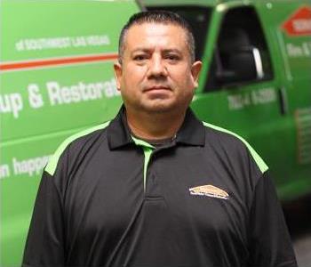 Male SERVPRO Technician with equipment as background