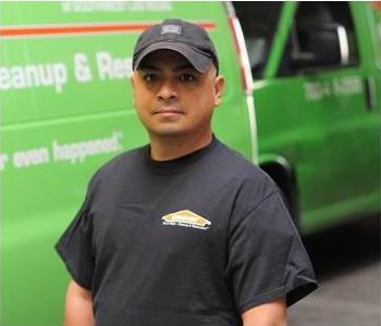 Male SERVPRO Technician with equipment as background