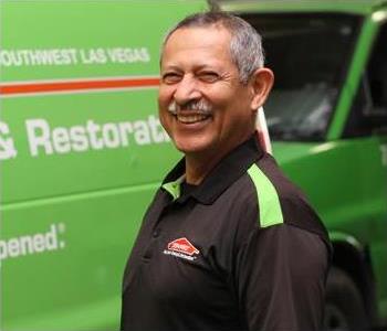 Male SERVPRO Technician with equipment as background