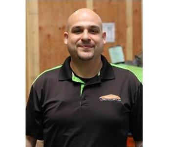 Male employee technician with crate in the background