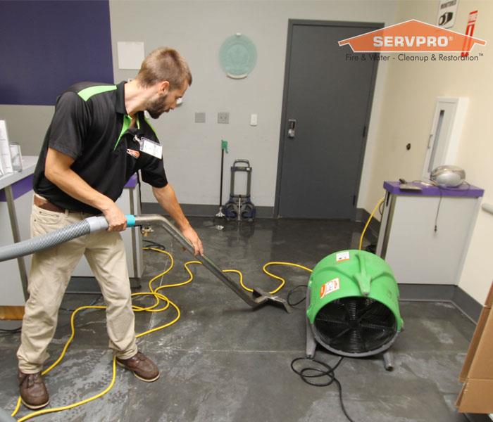 Extracting water from a commercial concrete floor that flooded in a Las Vegas business.
