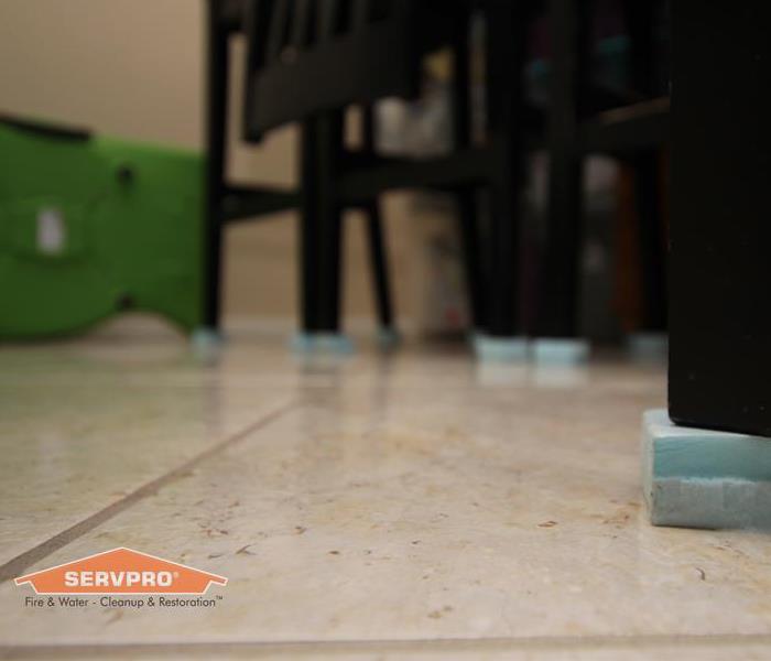 A dining room table and chairs on riser pads to avoid being damaged from the flood.