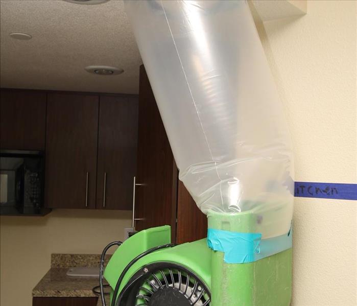 Using commercial-grade air movers to dry out a wet ceiling in a commercial kitchen in Las Vegas.